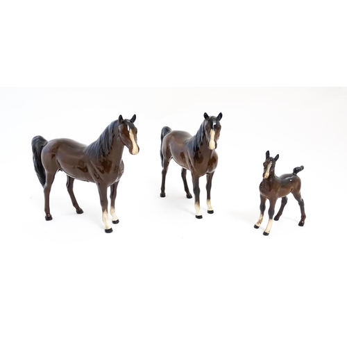 140 - Two Royal Doulton brown horses and a brown foal. Largest approx. 6 1/2