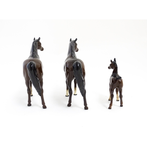 140 - Two Royal Doulton brown horses and a brown foal. Largest approx. 6 1/2