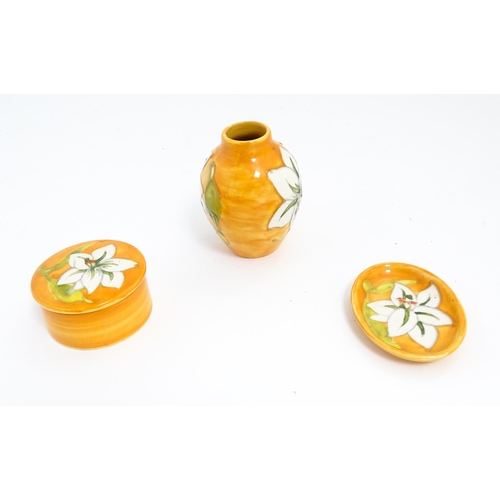 141 - Three items of Moorcroft decorated in the Bermuda Lily pattern comprising small vase, pin dish and p... 