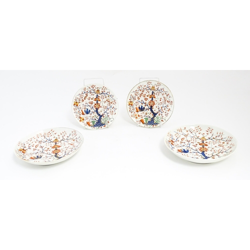 145 - Four Derby plates / dishes decorated in the Formal Lotus Tree pattern in a Japanese Kakiemon style. ... 