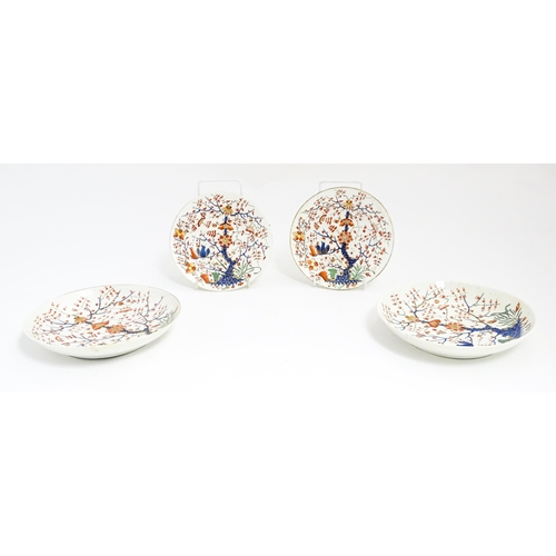 145 - Four Derby plates / dishes decorated in the Formal Lotus Tree pattern in a Japanese Kakiemon style. ... 