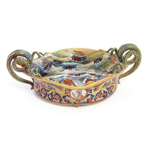 163 - An Italian lustre glazed maiolica bowl / dish with twin snake / serpent handles with hand painted de... 