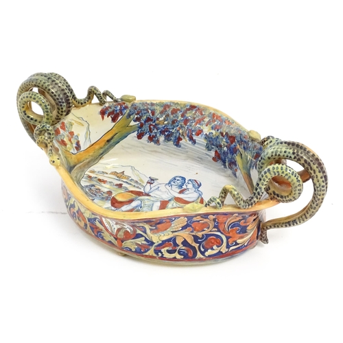 163 - An Italian lustre glazed maiolica bowl / dish with twin snake / serpent handles with hand painted de... 