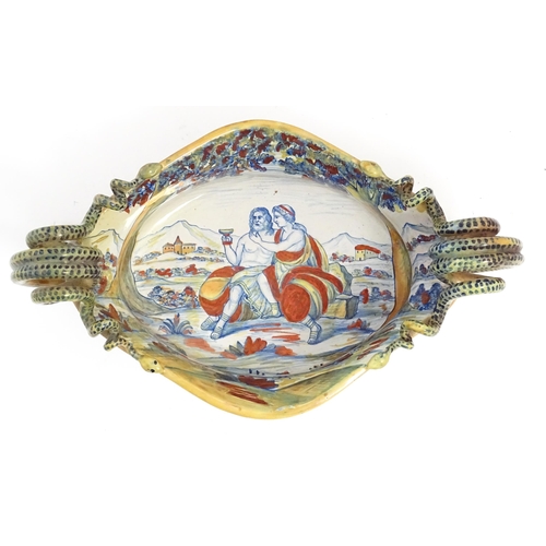 163 - An Italian lustre glazed maiolica bowl / dish with twin snake / serpent handles with hand painted de... 