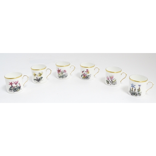 170 - A Royal Worcester coffee set, comprising 6 cups and saucers decorated with botanical decoration and ... 