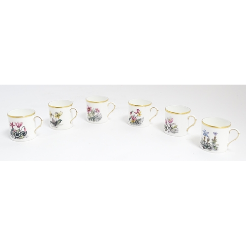 170 - A Royal Worcester coffee set, comprising 6 cups and saucers decorated with botanical decoration and ... 