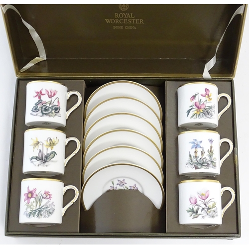 170 - A Royal Worcester coffee set, comprising 6 cups and saucers decorated with botanical decoration and ... 