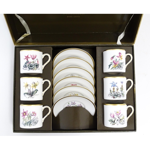 170 - A Royal Worcester coffee set, comprising 6 cups and saucers decorated with botanical decoration and ... 