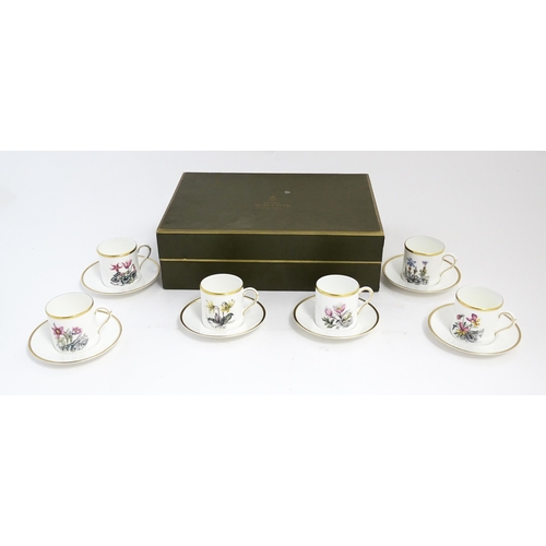 170 - A Royal Worcester coffee set, comprising 6 cups and saucers decorated with botanical decoration and ... 