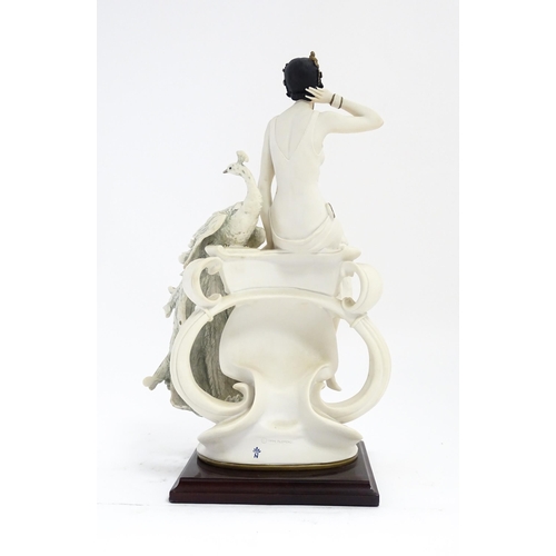 172 - An Italian Florence figure designed by Giuseppe Armani titled Garden Delight, depicting a seated lad... 