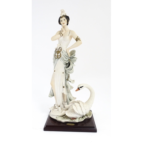 173 - An Italian Florence figure designed by Giuseppe Armani titled Swan Lake depicting a lady with a swan... 