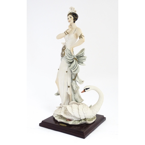 173 - An Italian Florence figure designed by Giuseppe Armani titled Swan Lake depicting a lady with a swan... 