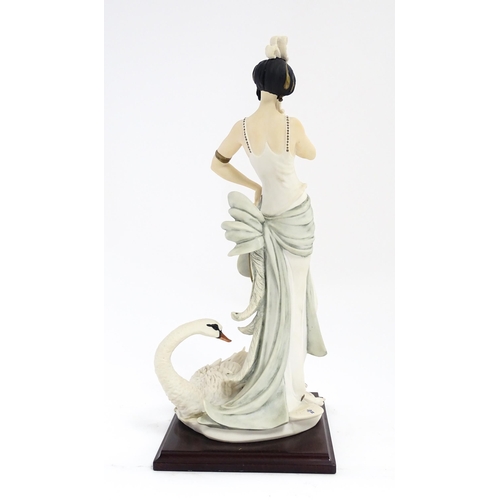 173 - An Italian Florence figure designed by Giuseppe Armani titled Swan Lake depicting a lady with a swan... 