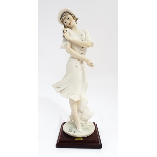 174 - An Italian Florence figure designed by Giuseppe Armani titled In Love depicting a lady holding a flo... 