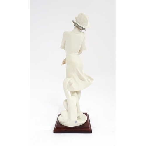 174 - An Italian Florence figure designed by Giuseppe Armani titled In Love depicting a lady holding a flo... 