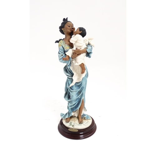 176 - An Italian Florence figure designed by Giuseppe Armani titled Magic Touch, depicting a mother and ch... 