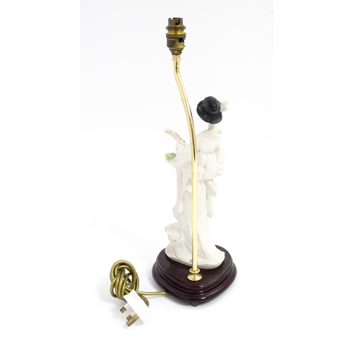 179 - An Italian Florence figural table lamp designed by Giuseppe Armani modelled as a Geisha girl with fl... 