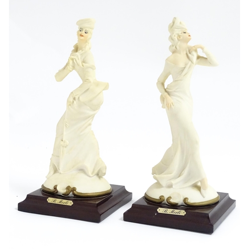 180 - A pair of Italian figural modelled as ladies, designed by B. Merli. Approx. 8 3/4