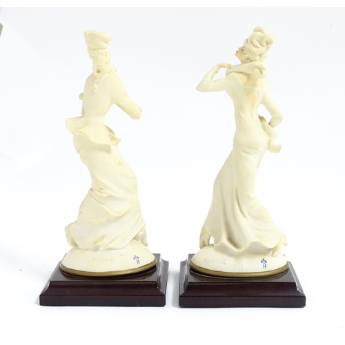 180 - A pair of Italian figural modelled as ladies, designed by B. Merli. Approx. 8 3/4