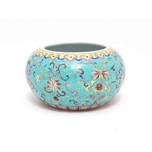 52 - A Chinese planter of bulbous form, the turquoise ground decorated in the famille rose palette depict... 