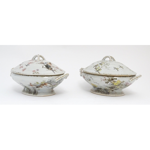 62 - A pair of Japanese tureens / lidded serving dishes with hand painted decorating various flowers and ... 