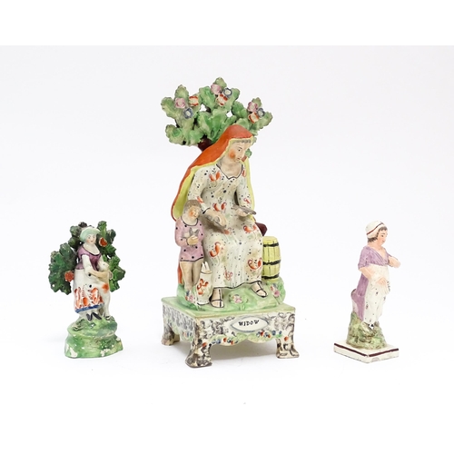 64 - A 19thC Staffordshire pottery figure group The Widow. Together with a Staffordshire bocage figure gr... 