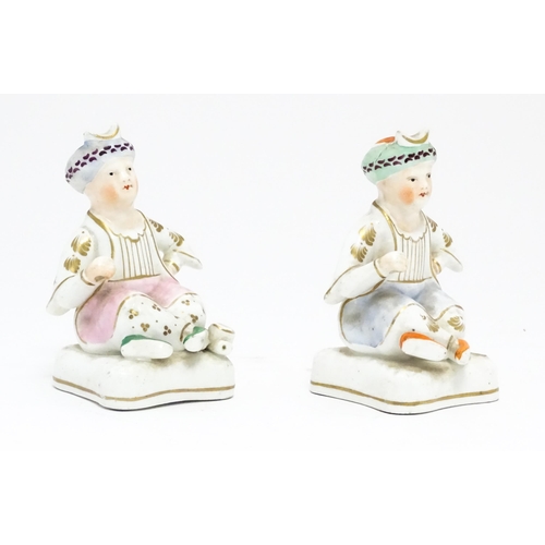 68 - Two Staffordshire models of seated Turkish gentlemen. Approx. 4 3/4