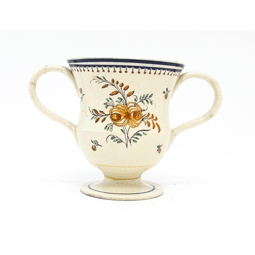 69 - A 19thC twin handled loving cup with hand painted decoration titled Peter Bates 1802 with floral and... 