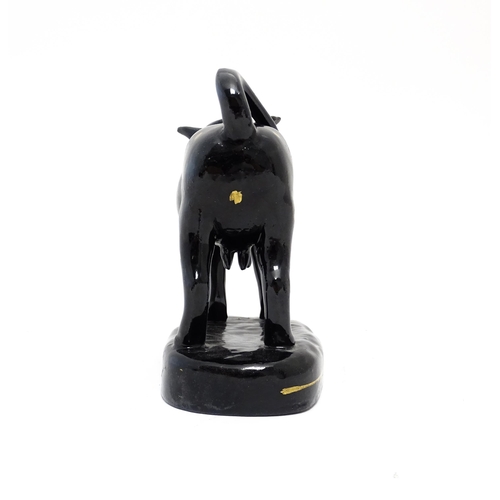 71 - A Staffordshire style black cow creamer with gilt spot detail. Approx. 5 1/4