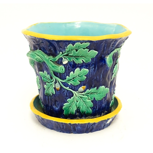 73 - A late 19th / early 20thC majolica planter and stand, the planter with bark, oak leaf and acorn deta... 