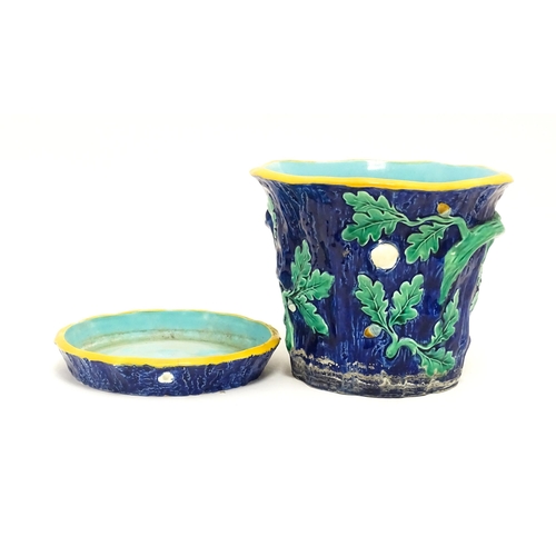 73 - A late 19th / early 20thC majolica planter and stand, the planter with bark, oak leaf and acorn deta... 