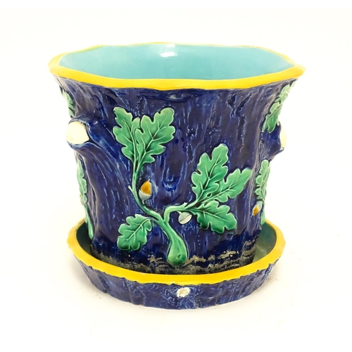 73 - A late 19th / early 20thC majolica planter and stand, the planter with bark, oak leaf and acorn deta... 