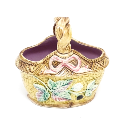 74 - A Victorian majolica basket with pink glazed interior, the woven style exterior with floral, foliate... 