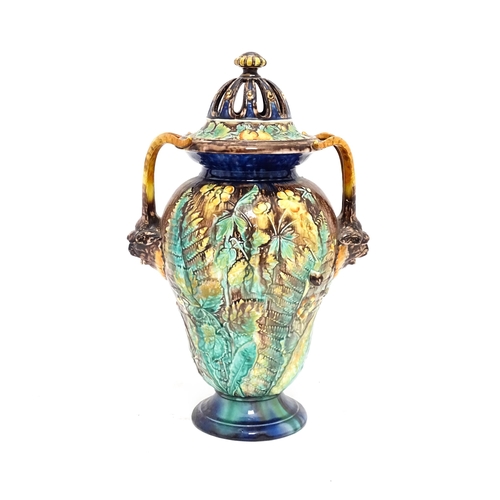 77 - A Royal Palissy majolica lidded vase with twin mask handles, the body decorated with a mottled glaze... 