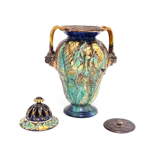 77 - A Royal Palissy majolica lidded vase with twin mask handles, the body decorated with a mottled glaze... 