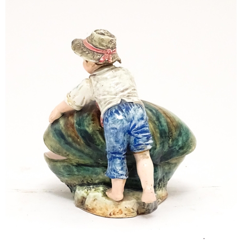 79 - A Continental majolica style dish modelled as a boy with a large shell. Impressed under 416. Approx.... 