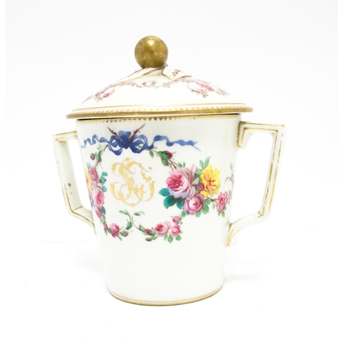 84 - A Sevres twin handled pot and cover decorated with floral garlands and bow detail, with gilt monogra... 