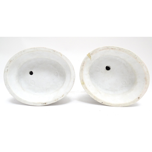 92 - A pair of French bisque porcelain male and female figures on naturalistic circular. Impressed A.M. m... 