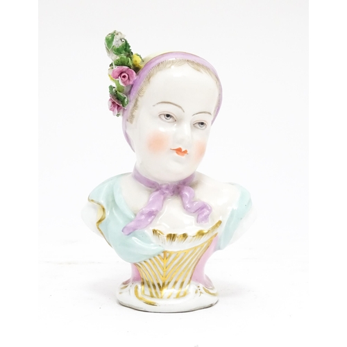 96 - A Continental porcelain bust depicting a young lady with flowers in her hair. Marked under. Approx. ... 