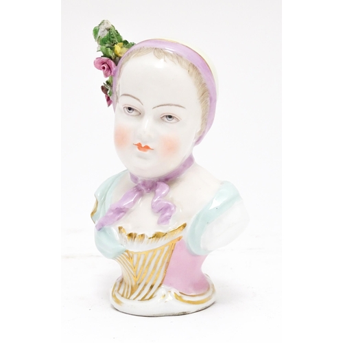 96 - A Continental porcelain bust depicting a young lady with flowers in her hair. Marked under. Approx. ... 