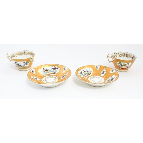 188 - Two 19thC English tea cups and saucers the orange ground decorated with hand painted exotic birds an... 