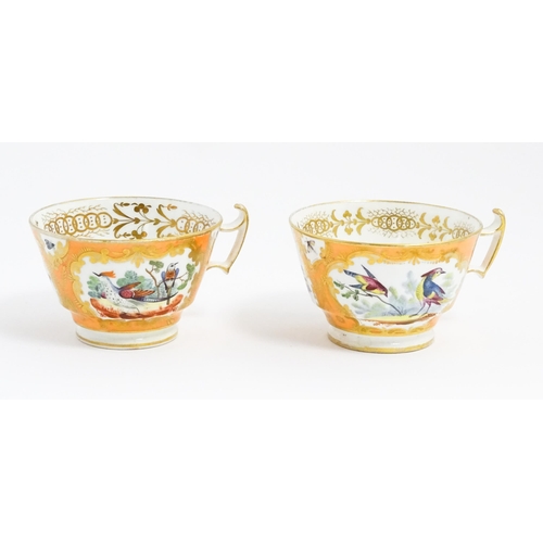 188 - Two 19thC English tea cups and saucers the orange ground decorated with hand painted exotic birds an... 