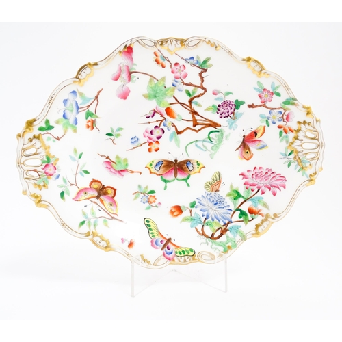 201 - A dish of shaped form with hand painted floral, foliate and butterfly decoration, with gilt highligh... 