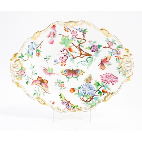 201 - A dish of shaped form with hand painted floral, foliate and butterfly decoration, with gilt highligh... 