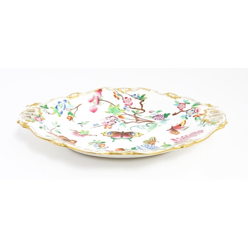 201 - A dish of shaped form with hand painted floral, foliate and butterfly decoration, with gilt highligh... 