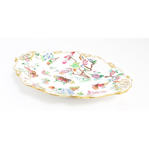 201 - A dish of shaped form with hand painted floral, foliate and butterfly decoration, with gilt highligh... 