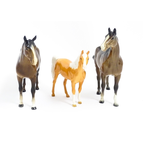 121 - Three Beswick models of horses comprising a brown horse with swish tail, no. 1182, a brown imperial,... 