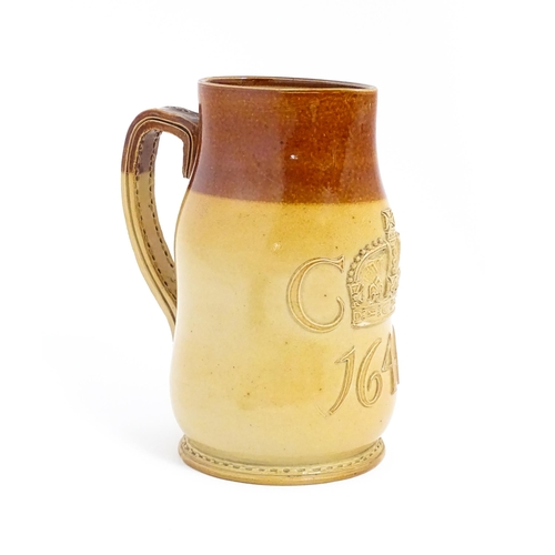 169 - A Doulton Lambeth jug of leather jack form with commemorative CR cipher dated 1646. Marked under no.... 