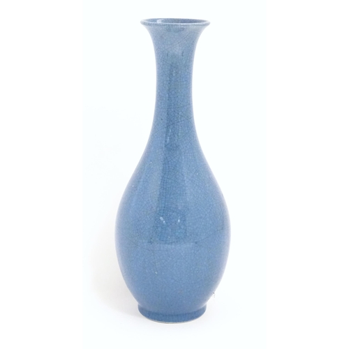 5 - A Chinese vase of elongated form with blue ground and crackle glaze. Approx. 16 1/2