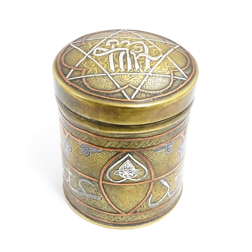 1070 - An early 20thC Middle Eastern brass pot and cover with engraved detail and inlaid white metal and co... 